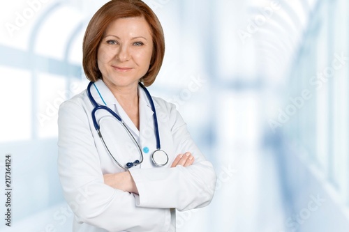 Young woman doctor with stethoscope writting