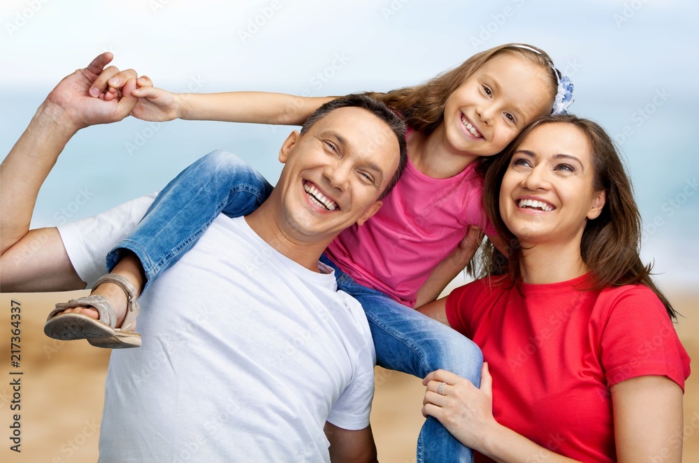 Happy smiling family with daughter over green Happy smiling family with daughter over green