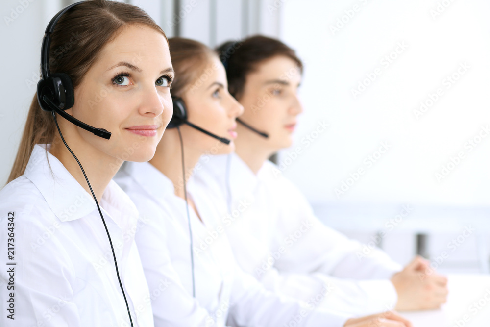 Call center. Focus on beautiful woman in headset Call center. Focus on beautiful woman in headset