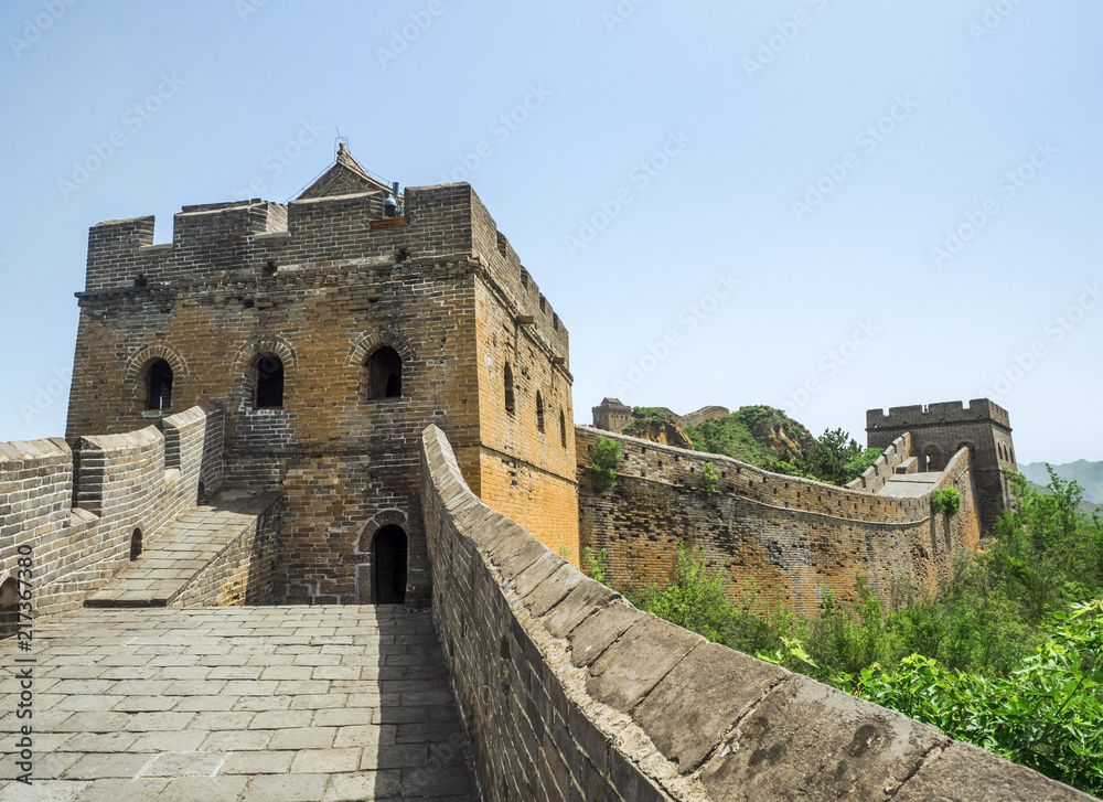 Fototapeta premium The Great Wall Jinshanling section with green trees in a sunny day, Beijing, China