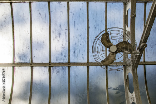 Fan on glass roof in a greenhouse
