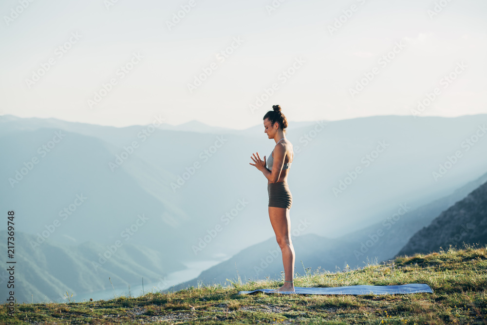 Fit young girl practicing yoga at sunset Fit young girl practicing yoga at sunset
