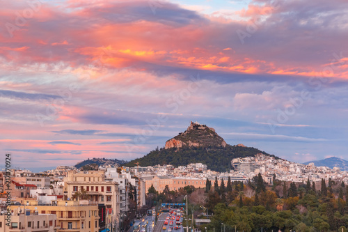 Obraz na plátně Mount Lycabettus towering above of the roofs of Old Town at gorgeous sunset in A