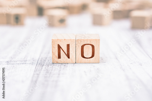 The Word No Formed By Wooden Blocks On A White Table