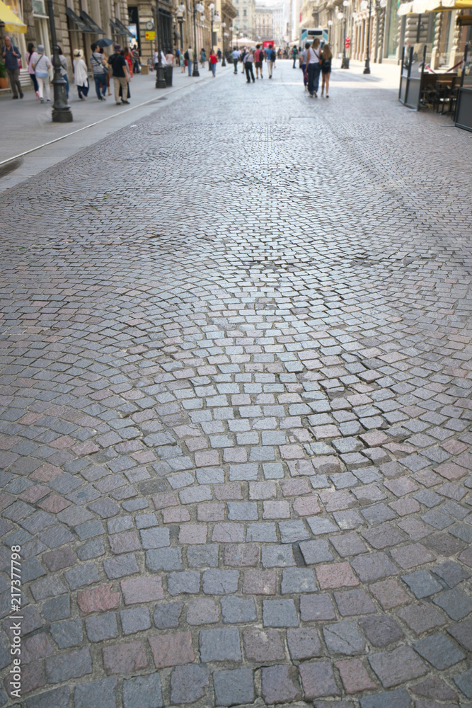 Milan,Italy-July 24, 2018: Stone pavement of Via Dante, an important and elegant pedestrian street in central Milan, Italy
