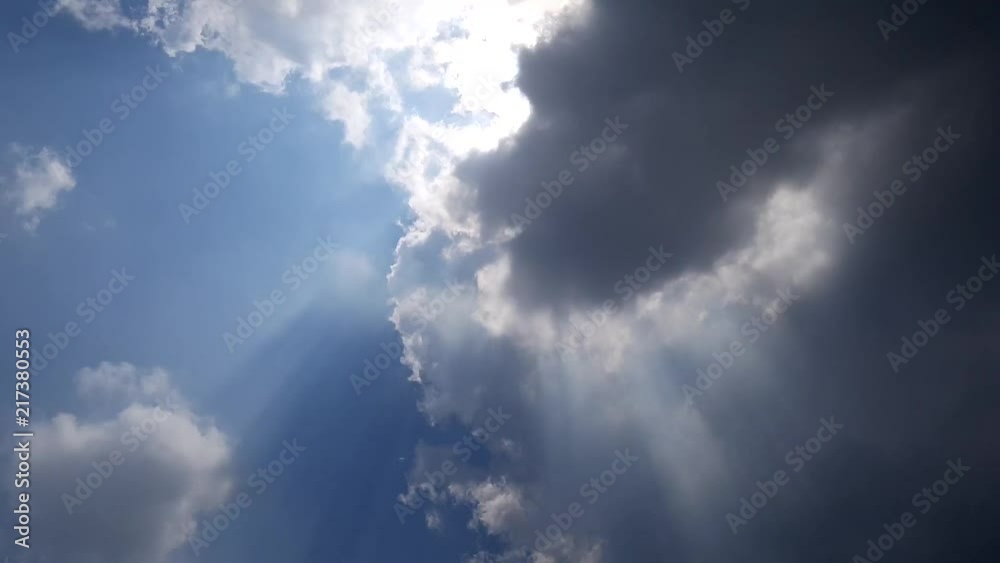 Time lapse sunbeam shine through the cloud on the blue sky . Sun rays Time lapse sunbeam shine through the cloud on the blue sky . Sun rays