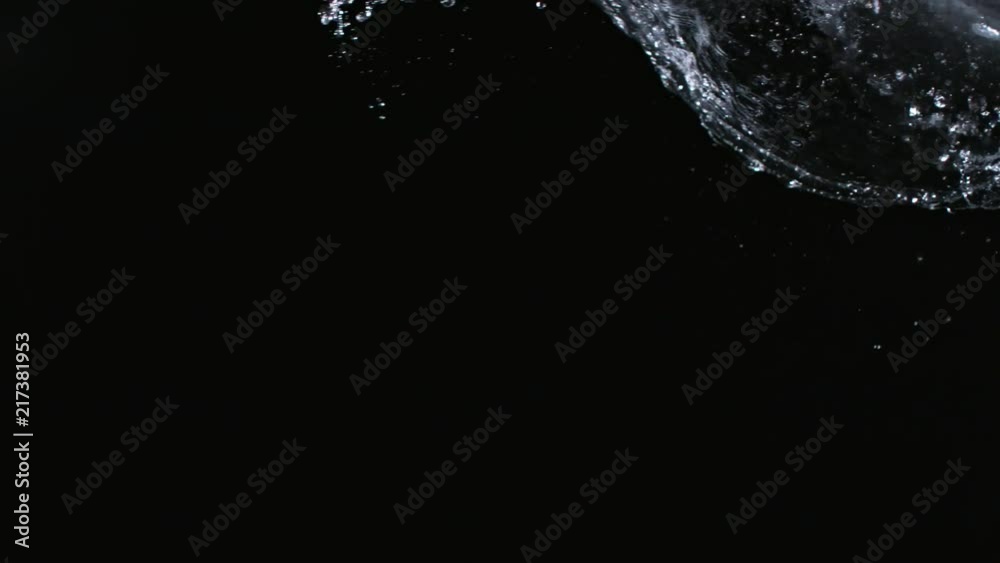 Super slow-motion shot of water splash against black. Shooted with high speed cinema camera at 1000fps Super slow-motion shot of water splash against black. Shooted with high speed cinema camera at 1000fps