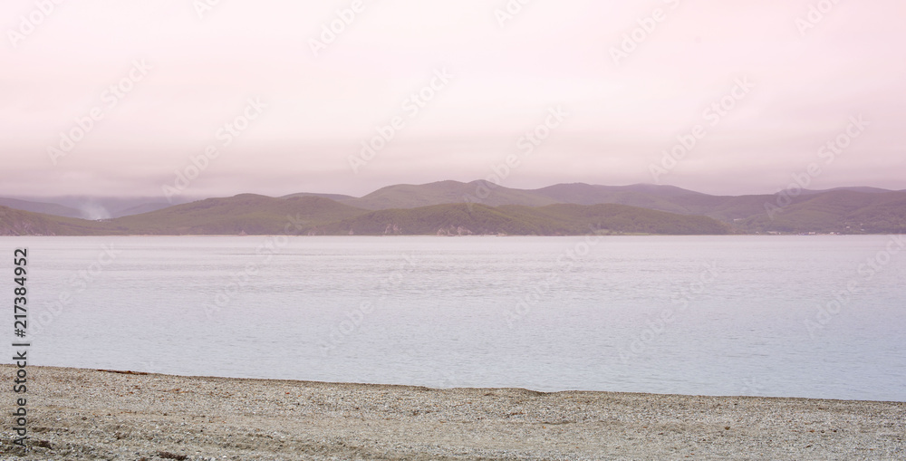 Banner seascape morning dawn horizon sea coast Bay hill sea pebble.