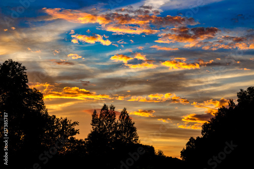 Bright beautiful sunset with clouds in summer  