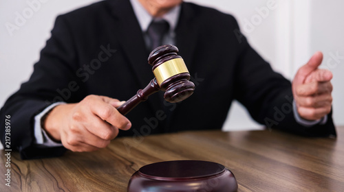Wallpaper Mural Male lawyer or judge hand's striking the gavel on sounding block, working at courtroom, Law and justice concept Torontodigital.ca