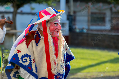 Hombre con máscara y traje de viejito bailando música tradicional mexicana photo