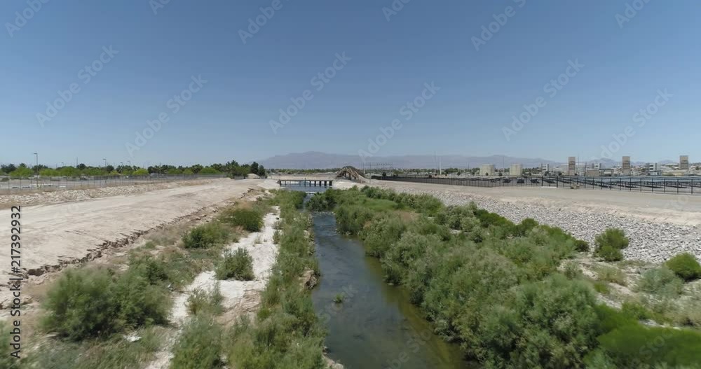 Aerial Drone Shot Flying Over Water Channel Towards Bridge On Busy Highway Aerial Drone Shot Flying Over Water Channel Towards Bridge On Busy Highway