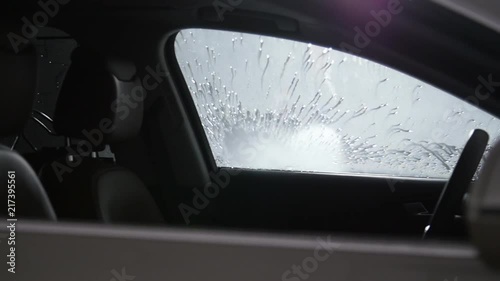 Man washes car with high pressure water photo