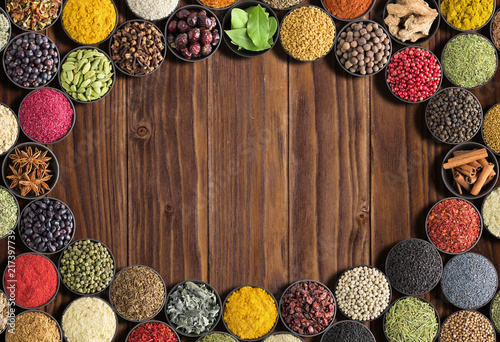 Indian Spices and herbs  with space for label. Various condiments on  wooden table, top view. Colorful seasoning for food