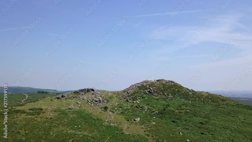 Wide shot aerial tracking forward towards Sharps Tor, in the heart of Devon, in the remote moorland of Dartmoor. Wide shot aerial tracking forward towards Sharps Tor, in the heart of Devon, in the remote moorland of Dartmoor.
