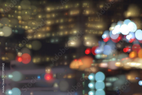 bokeh from office windows. power of money putting people to work overtime. multistory office building light up at night. modern architecture in the city