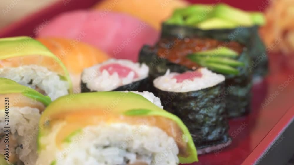 Sushi plate. Nigiri, sushi roll and maki sushi close up shot. Japanese food, slider shot Sushi plate. Nigiri, sushi roll and maki sushi close up shot. Japanese food, slider shot