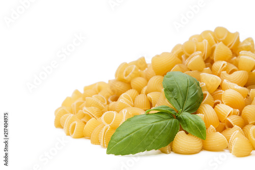 raw pasta with basil isolated on white