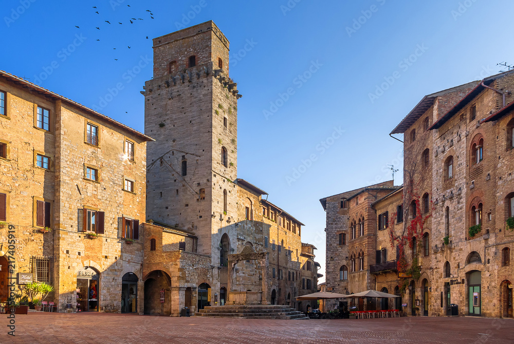 Panoramic view of famous Piazza della Cisterna in the historic town of San Gimignano on a sunny day, Tuscany, Italy