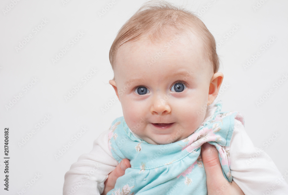 Baby being held under arms for a picture Baby being held under arms for a picture