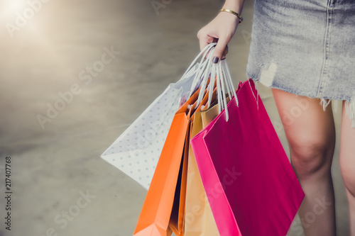 hand on holding shopping bags , she walking shopping