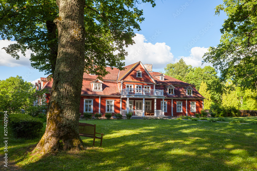 Old big wooden house in the park. Traditional scandinavian styled vintage living place.