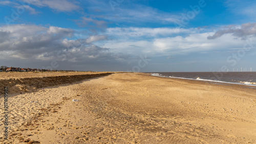 The beach in Great Yarmouth, Norfolk, England, UK - with some wind turbines of the Scroby Sands wind farm in the North Sea