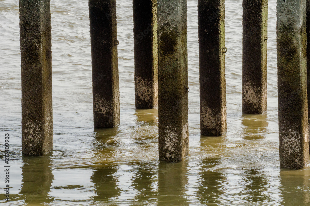 Foundation piles of pier make turbulence water flow or whirlpool in Chao Phraya river.