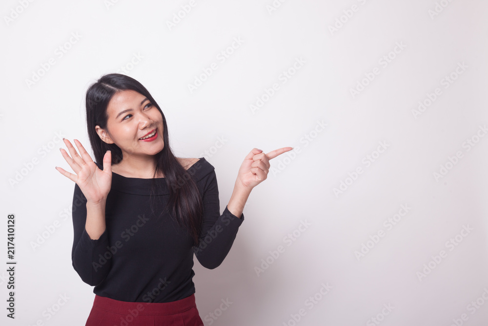Excited Asian woman point to blank space.