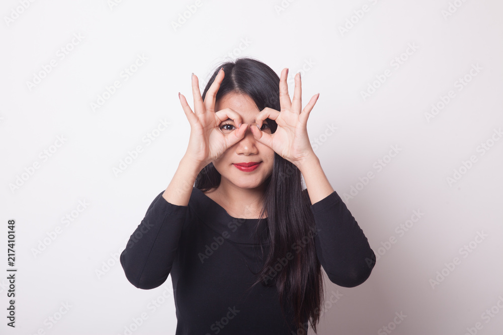Asian woman do funny double OK sign as glasses. Asian woman do funny double OK sign as glasses.