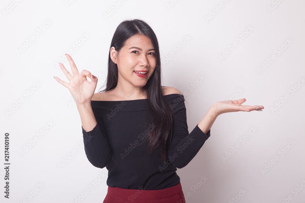 Beautiful young Asian woman show palm hand and OK sign. Beautiful young Asian woman show palm hand and OK sign.