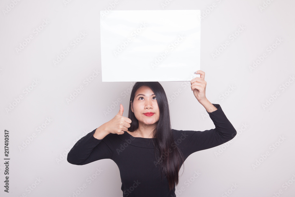 Young Asian woman show thumbs up with white blank sign. Young Asian woman show thumbs up with white blank sign.