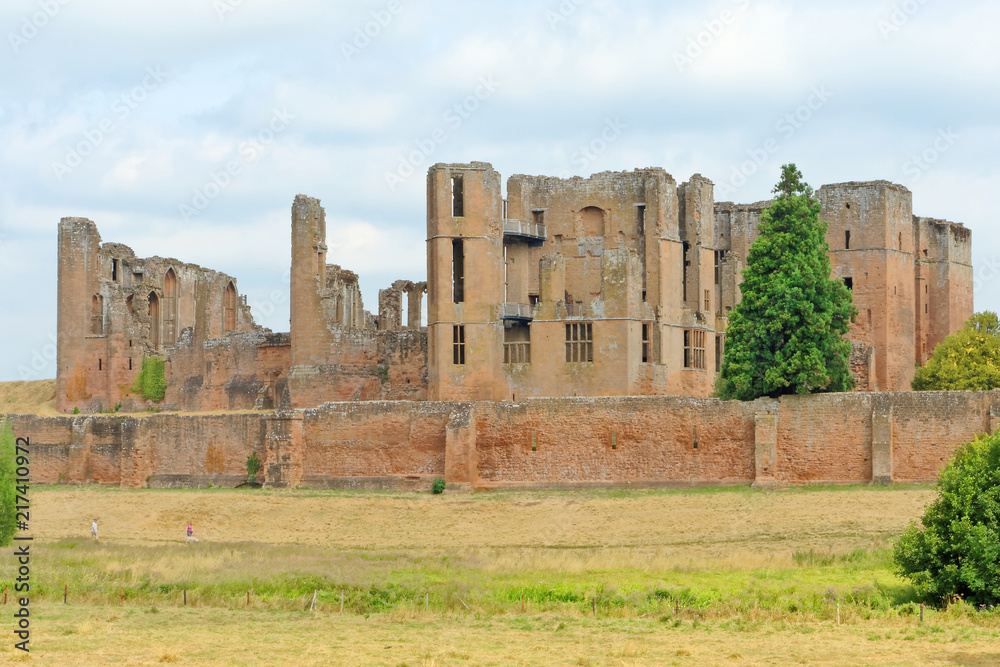 Kenilworth Castle ruins sheltered by a high defensive wall.