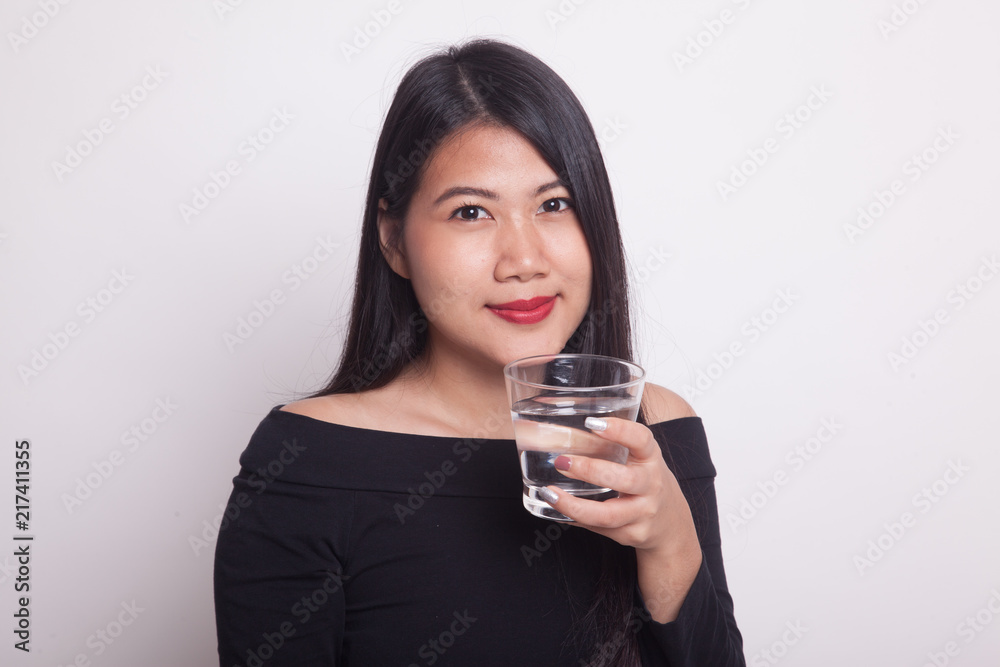 Young Asian woman with a glass of drinking water. Young Asian woman with a glass of drinking water.