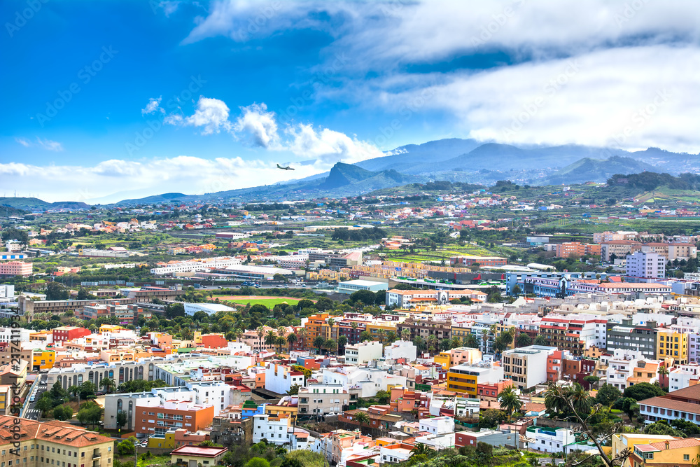 Aerial view of the residential area of Santa Cruz de Tenerife with airplane landing on Tenerife, Canary Islands. Spain