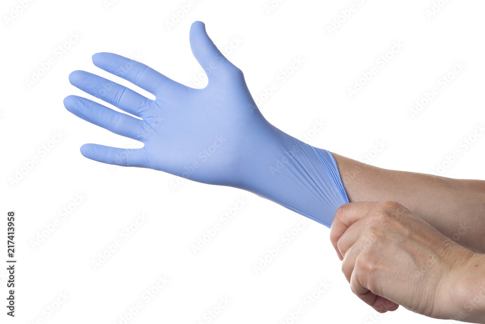 Doctor putting on sterile gloves isolated on white