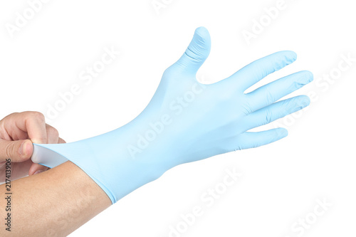 Doctor putting on blue sterilised medical glove for making operation