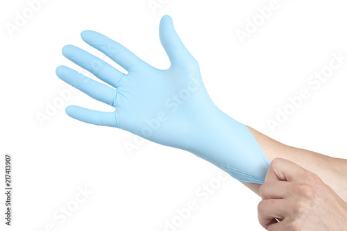 Doctor putting on blue sterilised medical glove for making operation © Object Studio