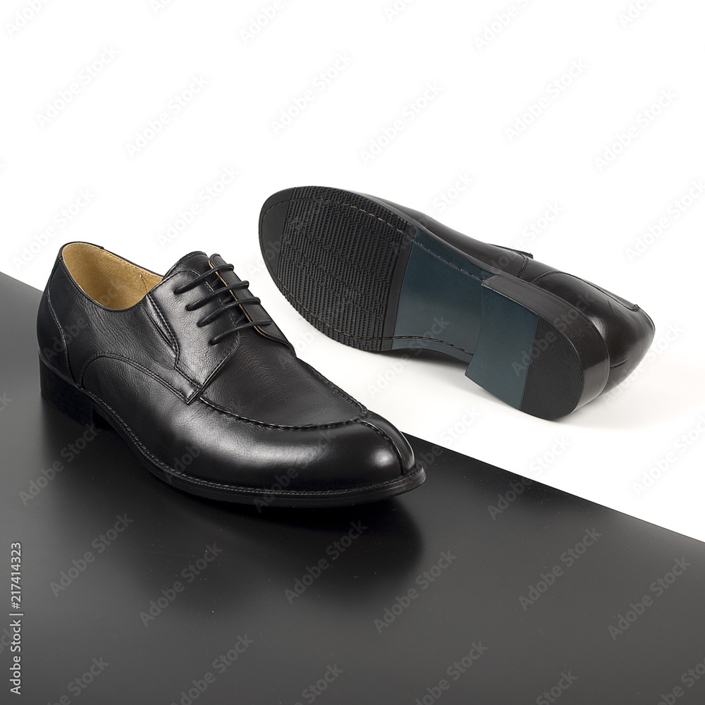 Pair of male shoes isolated on the white and black background Pair of male shoes isolated on the white and black background