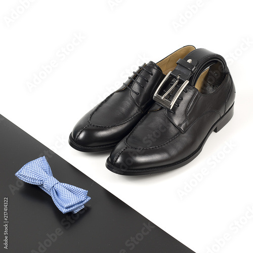 The black man's shoes and accessories isolated on white and black background.