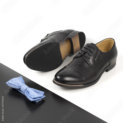 The black man's shoes and accessories isolated on white and black background.