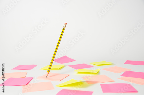 Pencil hanging in the air on a light background with stickers photo