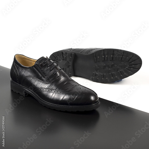 Pair of male shoes isolated on the white and black background