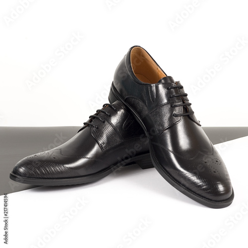 Pair of black male classic shoes on white background