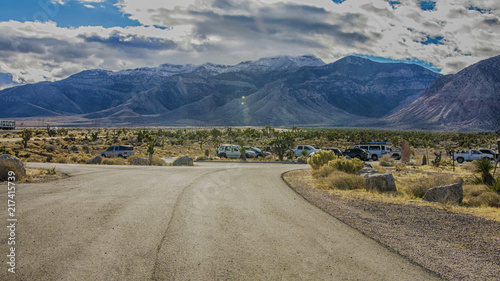Desert landscape with cars at parking in Nevada USA.