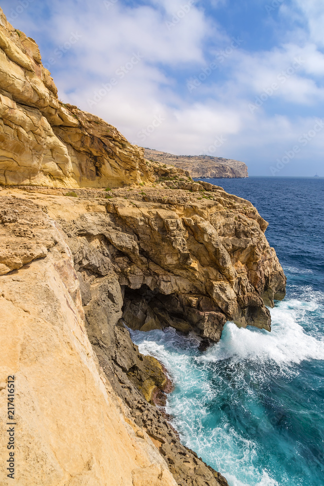 Wied Iz-Zurrieq, Malta. Coastal rocks washed with foaming water, in the southeast of the island Wied Iz-Zurrieq, Malta. Coastal rocks washed with foaming water, in the southeast of the island
