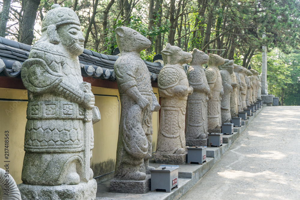 Animal god or mythology creature stone sculptures in Chinese culture. Text under each statues mean what animals are they. Animal god or mythology creature stone sculptures in Chinese culture. Text under each statues mean what animals are they.