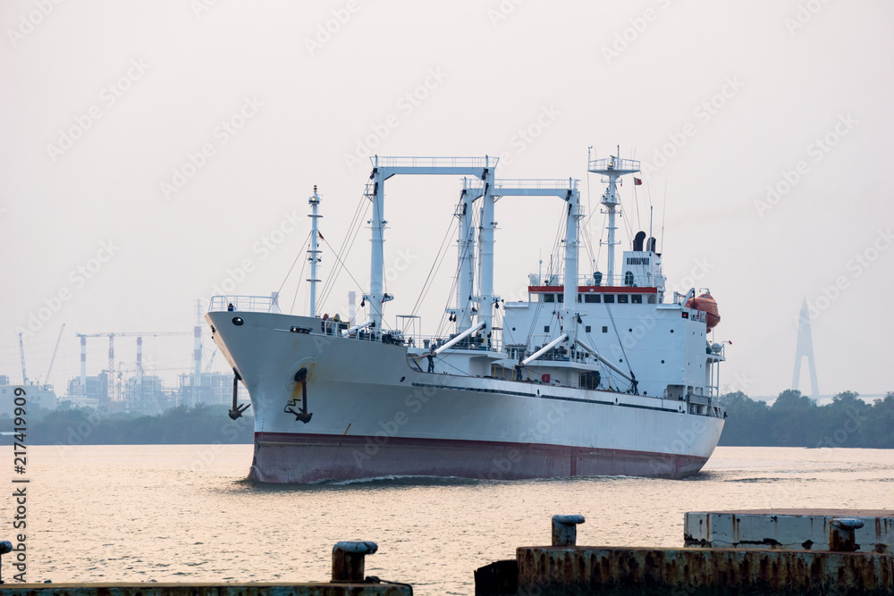 White reefer ship or refrigerated cargo ship sails in Chao Phraya river