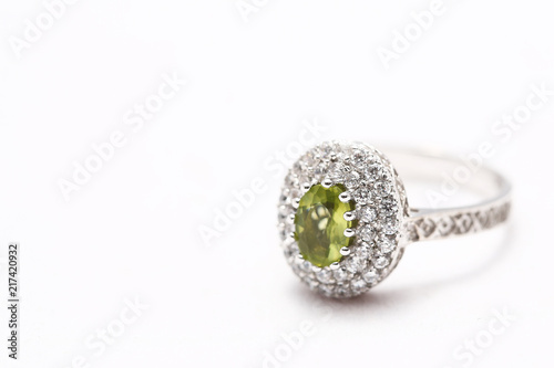 green gem stone on diamond ring