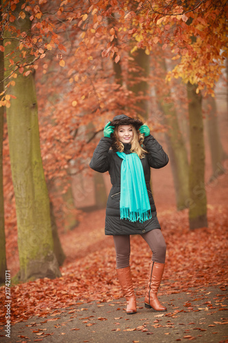 Attractive woman in autumnal park.